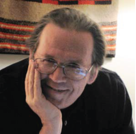 man smiling, chin in hand